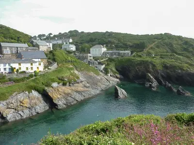 a small town on a river with houses on a cliff at Little Barn Cottage in Portloe