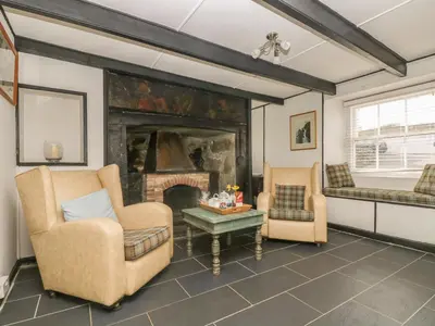 a living room with two chairs and a fireplace at Boundys House in St Ives