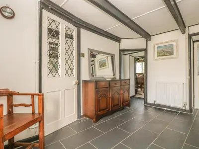 an empty room with a door and a table at Boundys House in St Ives