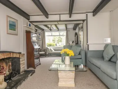 a living room with a couch and a fireplace at Boundys House in St Ives