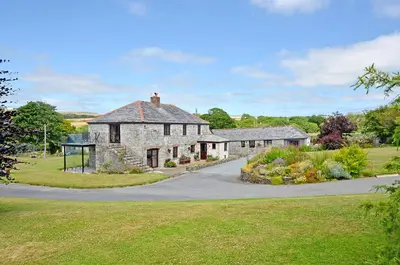 an old stone house on a road at Maple & Beech Barns in Truro
