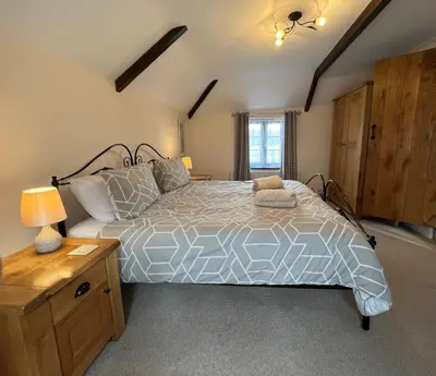 a bedroom with a large bed in a room at Maple & Beech Barns in Truro
