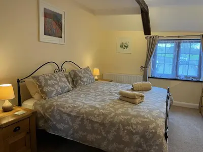 a bedroom with a bed with two pillows on it at Maple & Beech Barns in Truro
