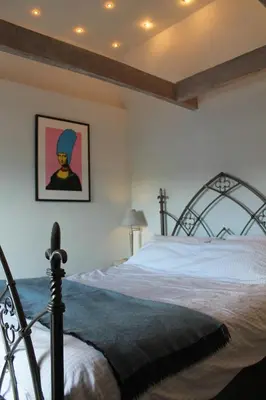 a bedroom with a bed with a metal frame at Sky Cottage in Golant village near Fowey in Fowey