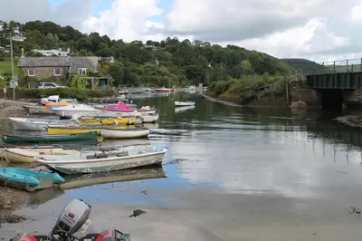 a group of boats are docked in a river at Sky Cottage in Golant village near Fowey in Fowey