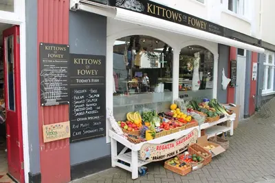 a fruit and vegetable stand in front of a store at Sky Cottage in Golant village near Fowey in Fowey
