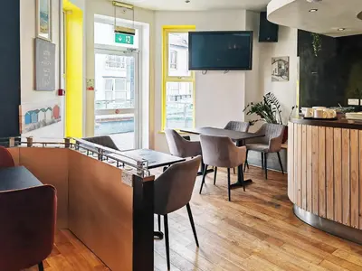 a restaurant with a dining room with a table and chairs at Town Lodge in Newquay