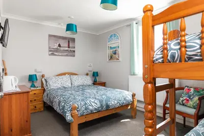 a bedroom with a bunk bed and a desk at Kenton in Newquay
