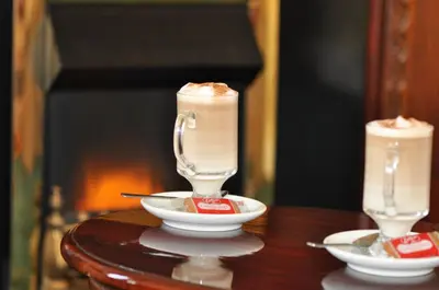 a table with two glasses with a dessert in it at The Hannafore Point Hotel in Looe