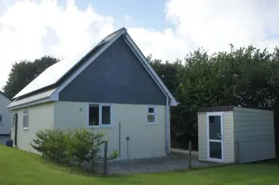 a small white house with a gambrel roof at The annex, Ruthvose in Saint Columb Major