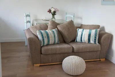 a living room with a couch and a table at The annex, Ruthvose in Saint Columb Major