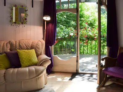 a living room with a couch and an open door at Beach Retreat - Ukc2322 in Carbis Bay