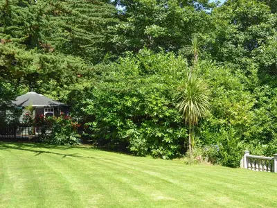 a grassy yard with a gazebo in the background at Beach Retreat - Ukc2322 in Carbis Bay