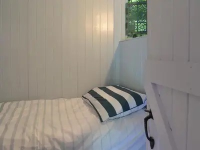 a small white room with a bed with a pillow at Beach Retreat - Ukc2322 in Carbis Bay