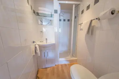 a bathroom with a toilet and a sink and a shower at St Breca in Newquay