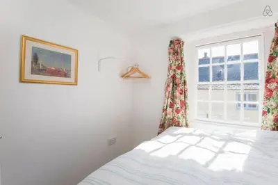 a bedroom with a bed and a window at Fisherman's Cottage in Saint Mawes