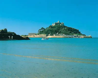 a castle on top of an island in the water at Tehidy Holiday Park in Illogan