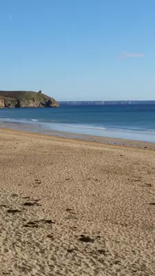 a sandy beach with the ocean in the background at Mandeley Guest House in Helston