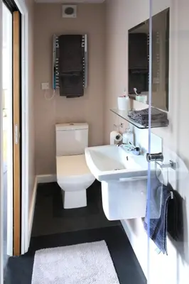 a bathroom with a white toilet and a sink at Little Trewin in Helston