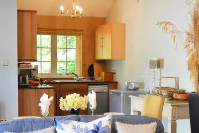 a kitchen with a couch and a table in a room at Spring Water Barn in Helston