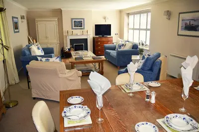 a living room with a table and chairs at St Corantyn Cottage in Helston