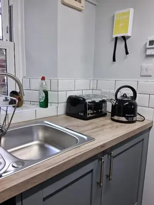 a kitchen counter with a sink and a toaster at Ivy Cottage, in Lostwithiel