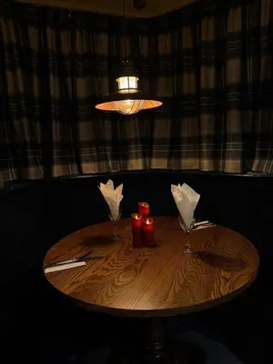 a wooden table with two napkins and two glasses at Tyacks Hotel in Camborne