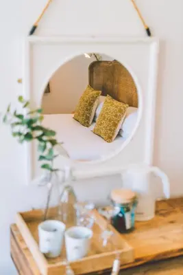 a mirror on top of a wooden table at Primrose House St. Ives in St Ives