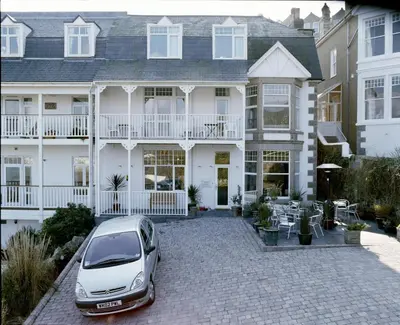 a car parked in front of a large house at Primrose House St. Ives in St Ives