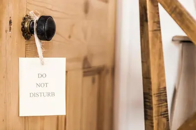 a door knob with a do not disturb sign on it at Primrose House St. Ives in St Ives