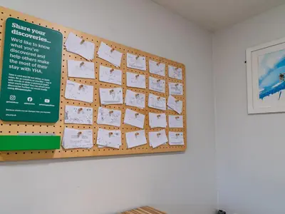 a bulletin board on a wall in a room at YHA Treyarnon Bay in Padstow