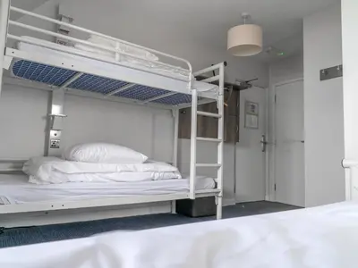 a bedroom with two bunk beds in a room at YHA Treyarnon Bay in Padstow