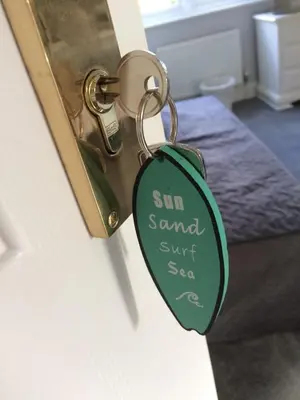 a key chain that reads sun sandwich surf seasea at Olcote House in Padstow