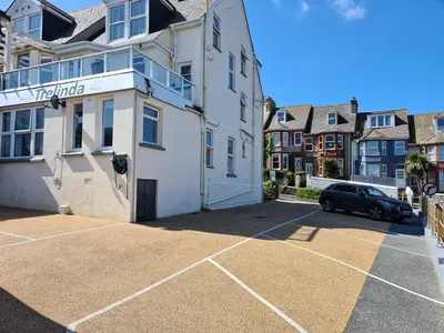 a parking lot in front of a white building at The Trelinda Guest House in Newquay