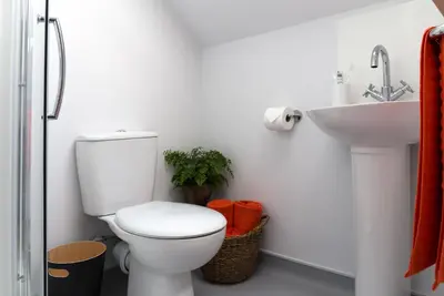 a bathroom with a toilet and a sink at Roseland House in Falmouth