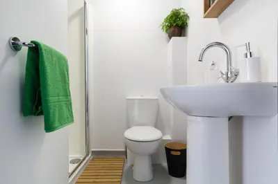 a bathroom with a white toilet and a sink at Roseland House in Falmouth
