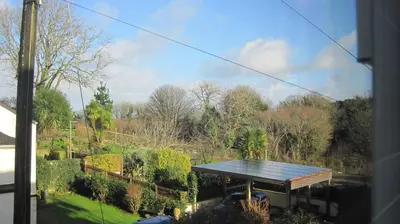 a view of a garden from a window of a house at Glengarth in Penryn