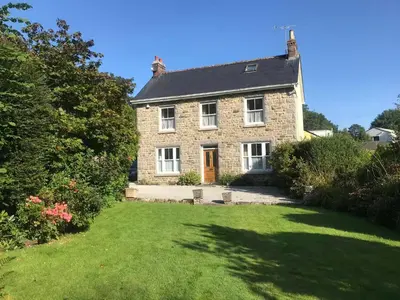 a large stone house with a large yard at Glengarth in Penryn
