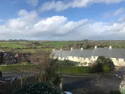 a view of a village with houses and fields at Wellingtons in Fowey