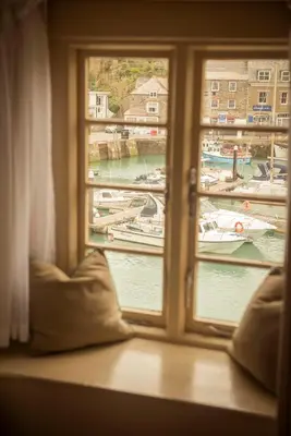 a window with a view of boats in a harbor at The Old Custom House in Padstow