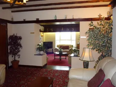 a living room with a couch and a table at Priory Lodge Hotel in Newquay