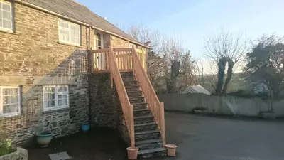 a wooden staircase leading up to a house at The Hayloft in Bude