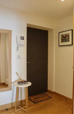 a black door in a room with a small table at Endcliffe in Falmouth