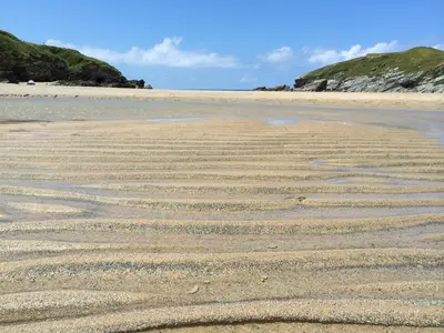 a beach with a pattern in the sand at 9 Sandpiper Cottages in Newquay