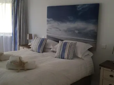 a bedroom with two beds with a starfish on the bed at 9 Sandpiper Cottages in Newquay