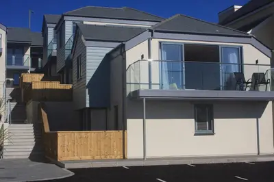 a house with a balcony on the side of it at 9 Sandpiper Cottages in Newquay