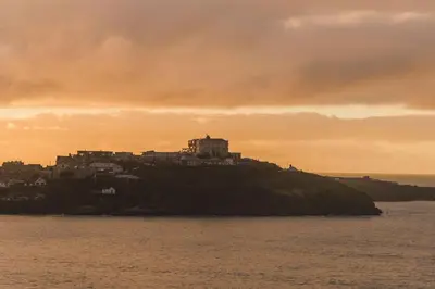 a castle on top of an island in the water at Panoramic Sea-View Family Appartment , Free Parking, Sleeps 6 , Walk to Beach, Station, & Town in Newquay