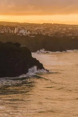 a view of the ocean with a city in the background at Panoramic Sea-View Family Appartment , Free Parking, Sleeps 6 , Walk to Beach, Station, & Town in Newquay