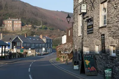 an empty street in a town with a stone building at The Wellington Hotel in Boscastle