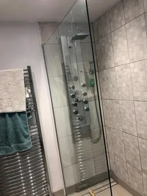 a shower with a glass door in a bathroom at Priory Cottage Bodmin in Bodmin